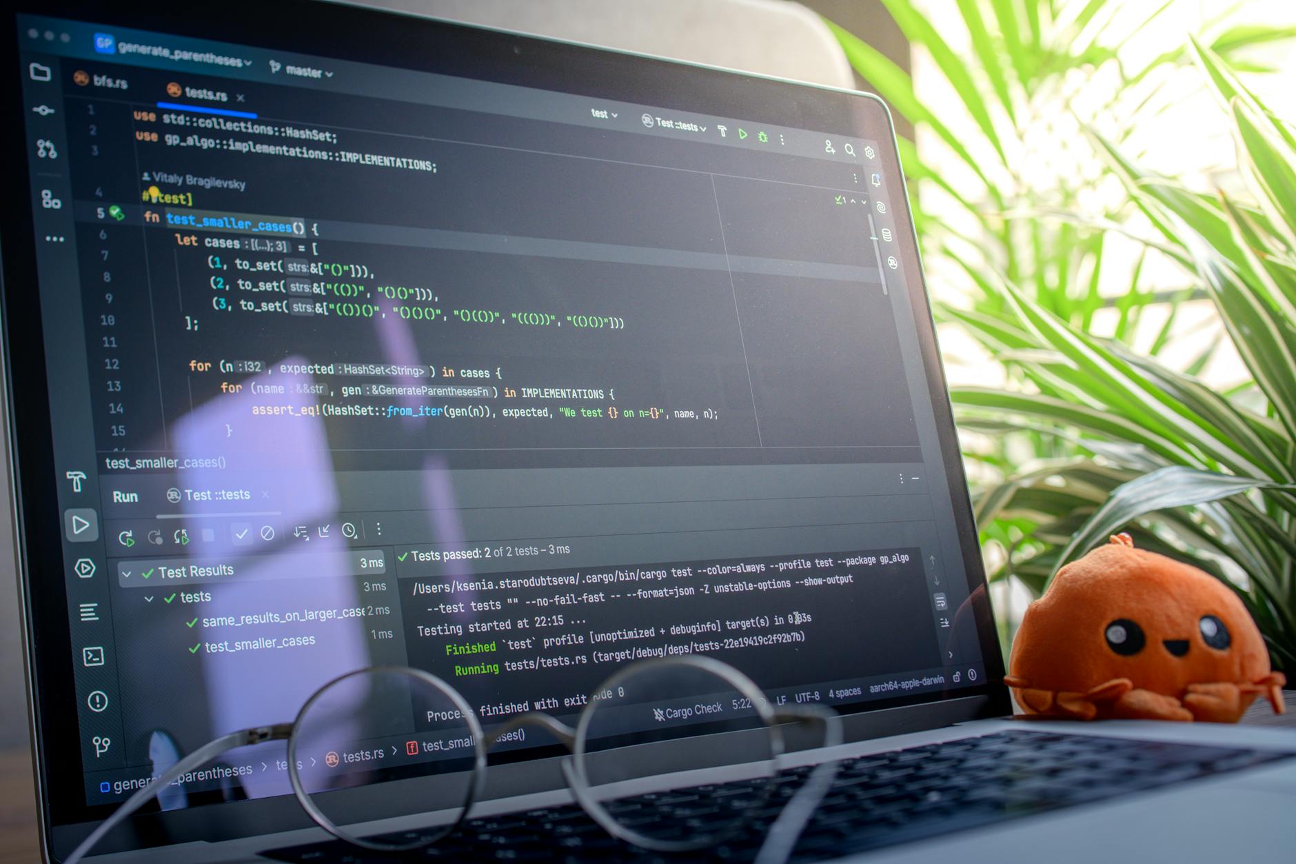 Laptop displaying code and data charts in a bright workspace