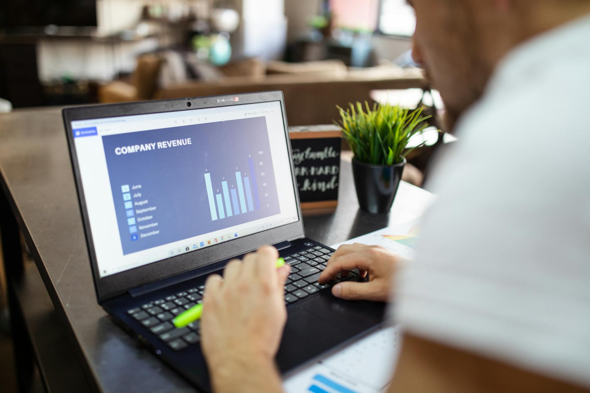 Analyst reviewing recurring revenue charts on a laptop
